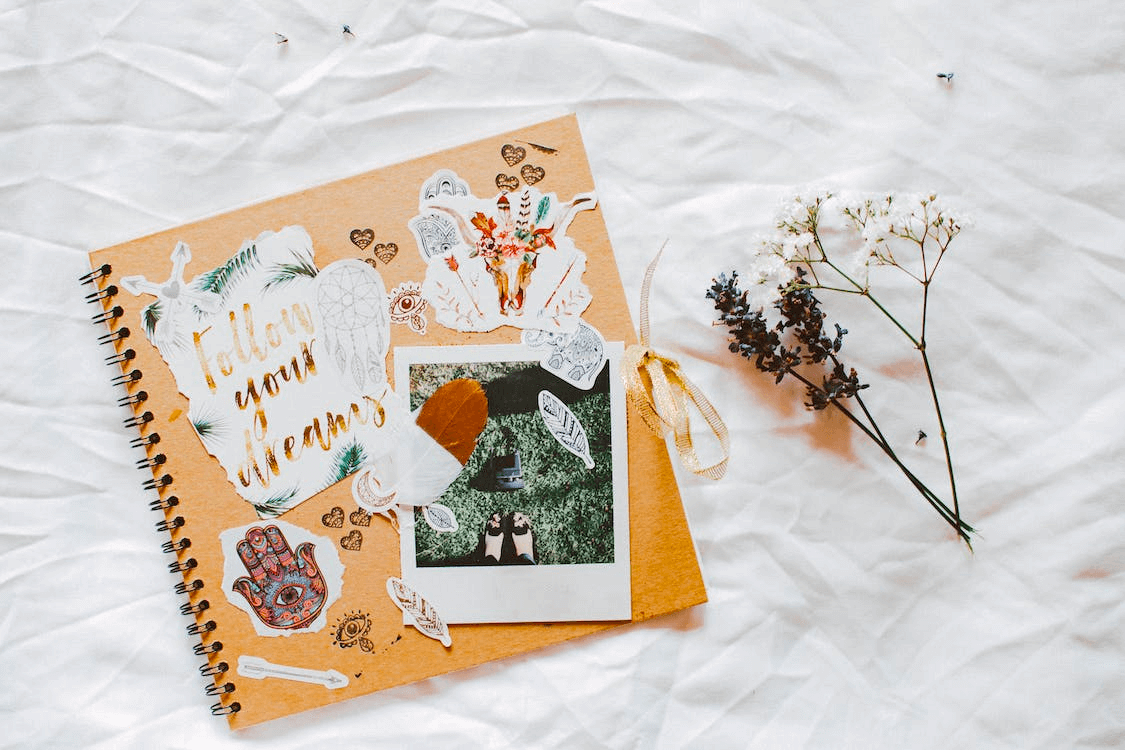 Scrapbook and dry flowers on a sheet