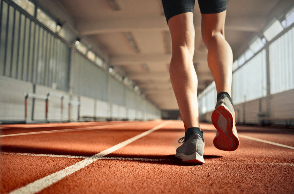 Person running on an indoor track