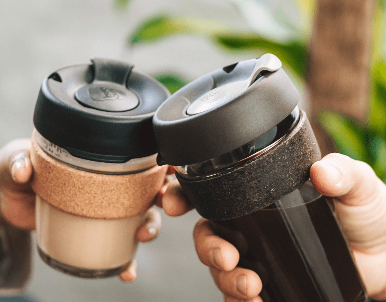 People enjoying coffees in reusable cups