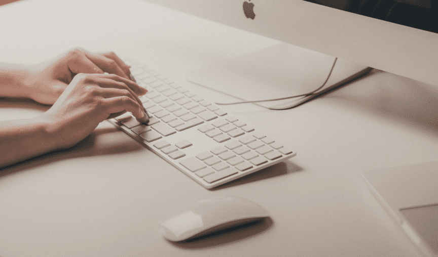 Hands working at a computer