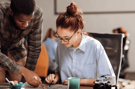 This is an image of 2 people working together.