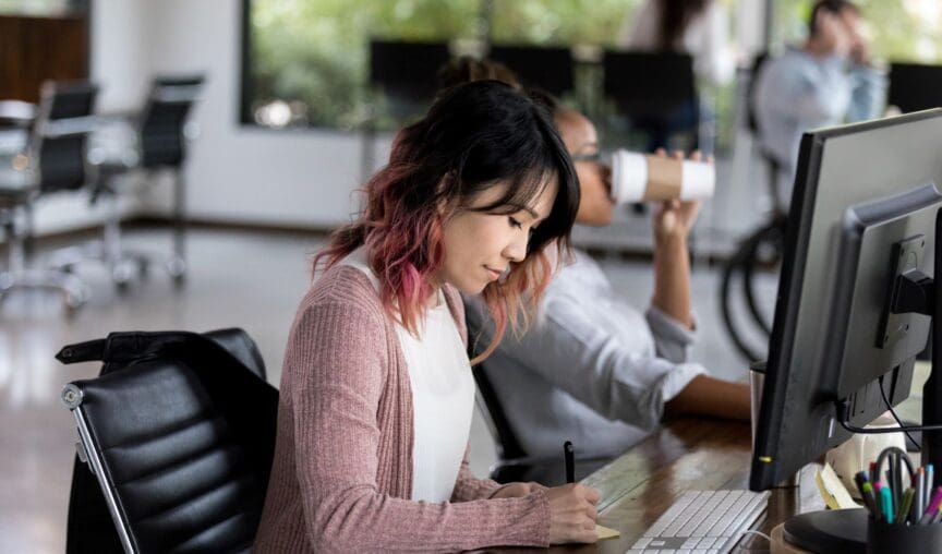 Image of a woman sitting at her desk working