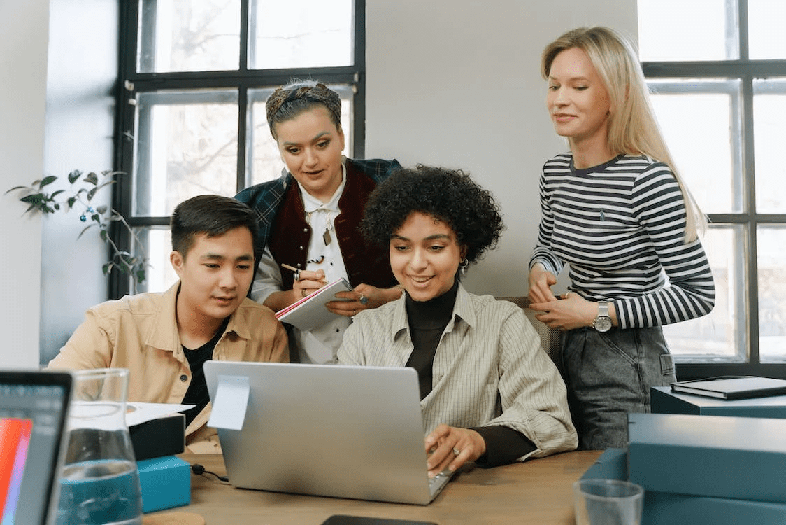 group of diverse employees sitting around the table discussing 