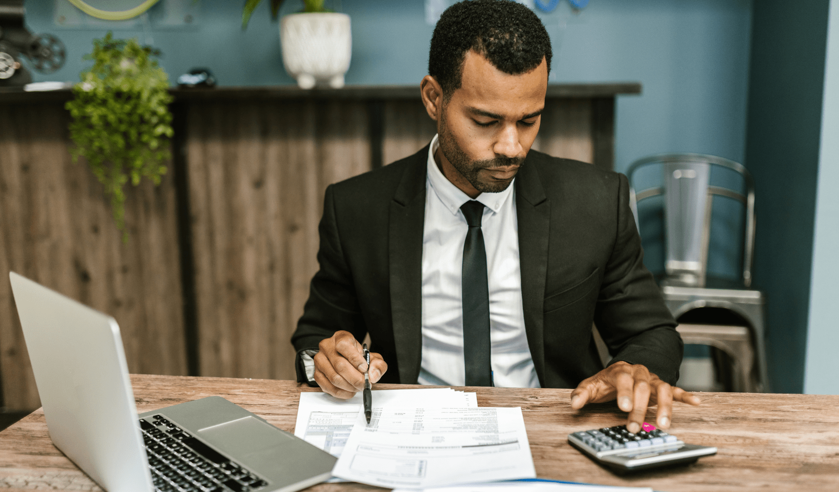 man calculating at his desk