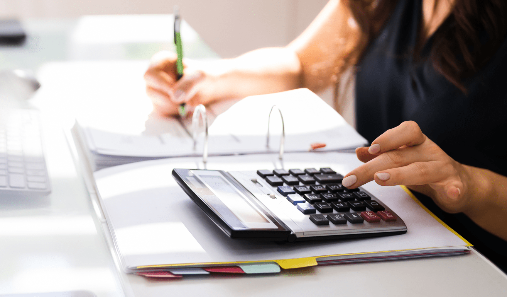 woman using the calculator at work